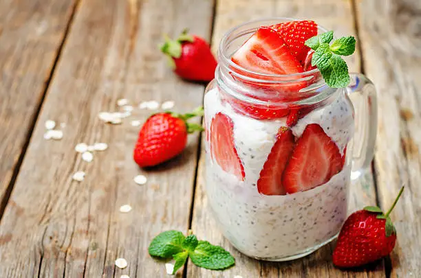 homemade healthy Chia seeds and strawberry overnight oatmeal in jar. toning. selective Focus
