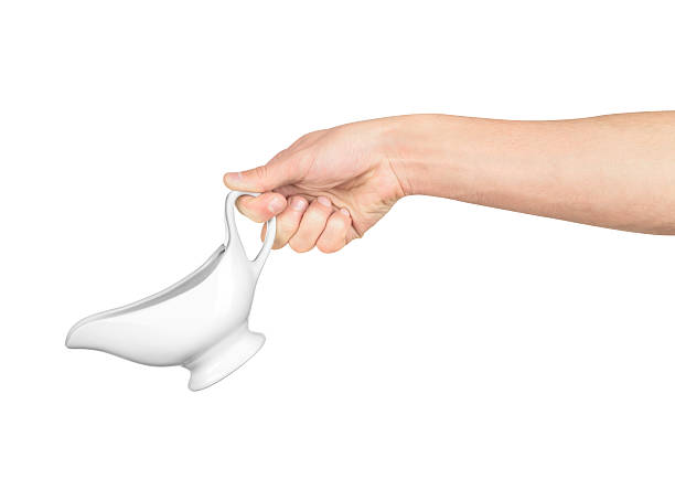 hand holds white gravy boat hand holds white gravy boat isolated on white background gravy stock pictures, royalty-free photos & images