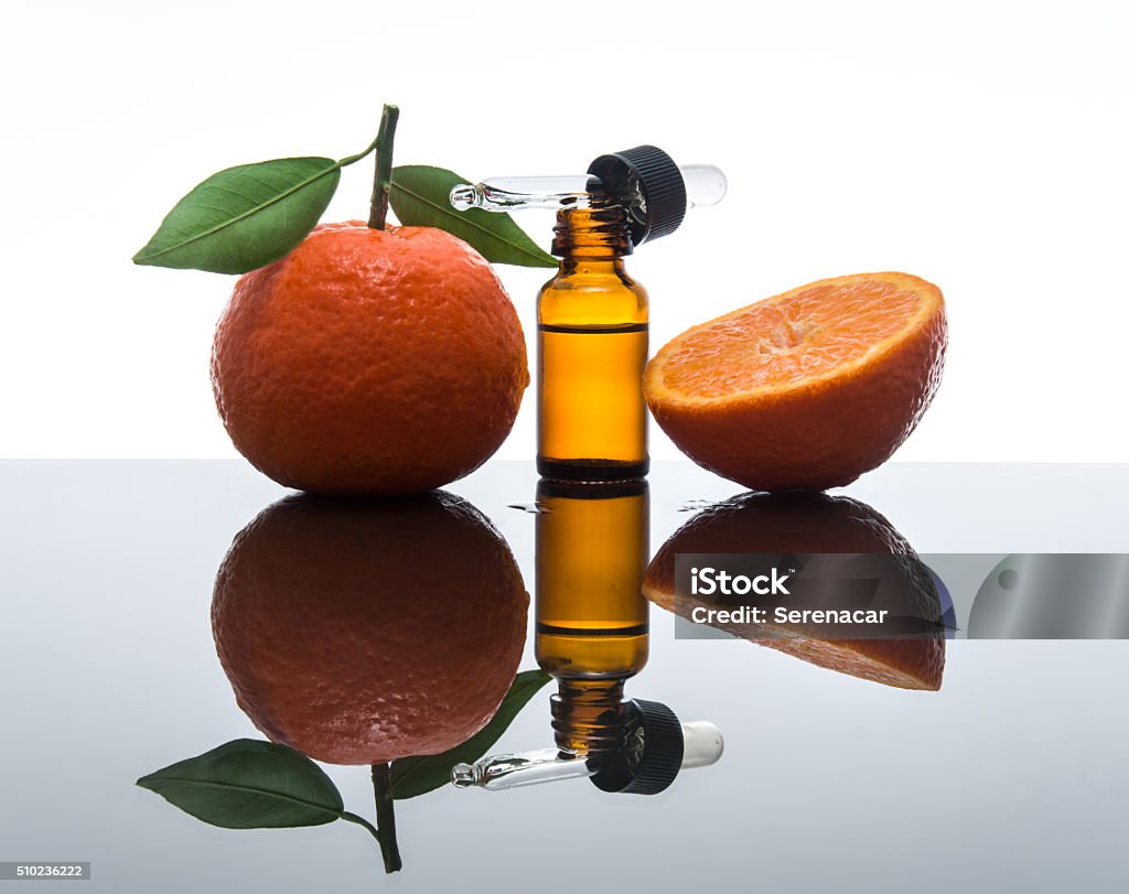 Tangerine / Mandarin essential oil bottle with dropper Essential oil of mandarin (Citrus reticulate) is obtainer by cold pressing the rind ( peel).  Vitamin C Stock Photo