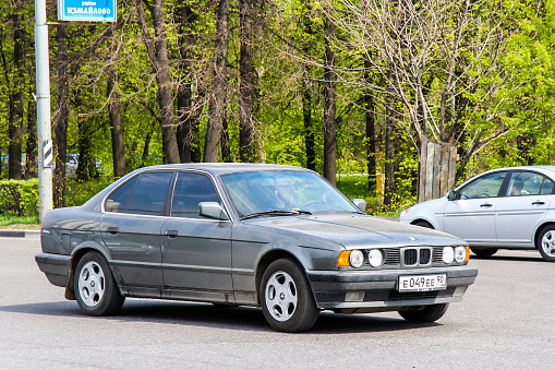 Moscow, Russia - May 5, 2012: Motor car BMW E34 5-series drives in the city street.