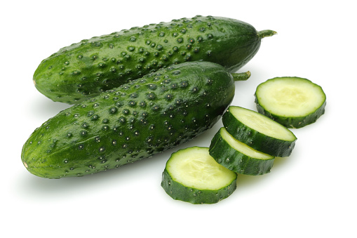 Fresh organic cucumbers on white