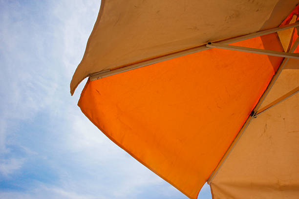 istock Orange parasol on a sunny day 510242468