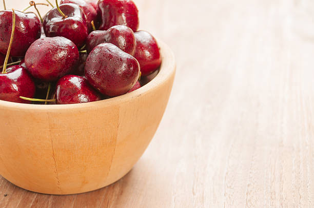 istock Fresh cherries in bowl on table 510243371