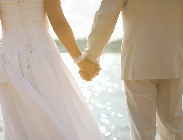 istock Bride and groom holding hands 510243755