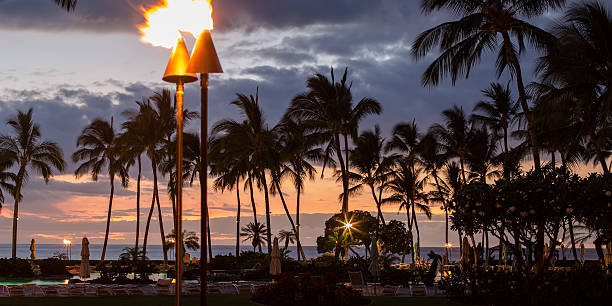 Tiki Lamps Scene of a beach area at night tiki torch stock pictures, royalty-free photos & images