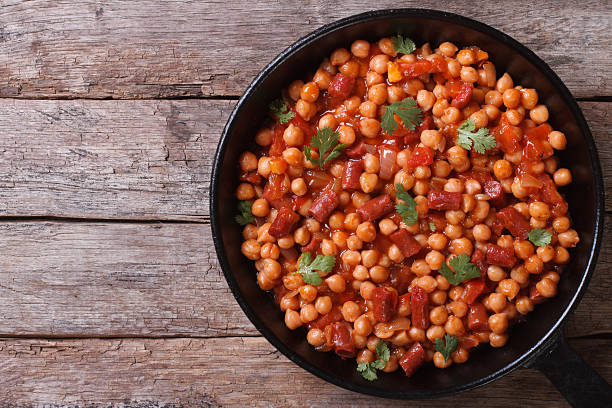 istock Chickpeas with chorizo in a pan top view 510247321