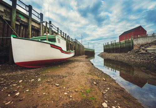 Fishing boats sit on the ocean floor in the tiny fishing village of Halls Harbour on the Bay of Fundy.