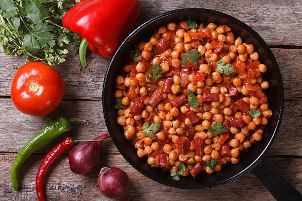 istock Chickpeas with chorizo in a pan with ingredients top view 510266867