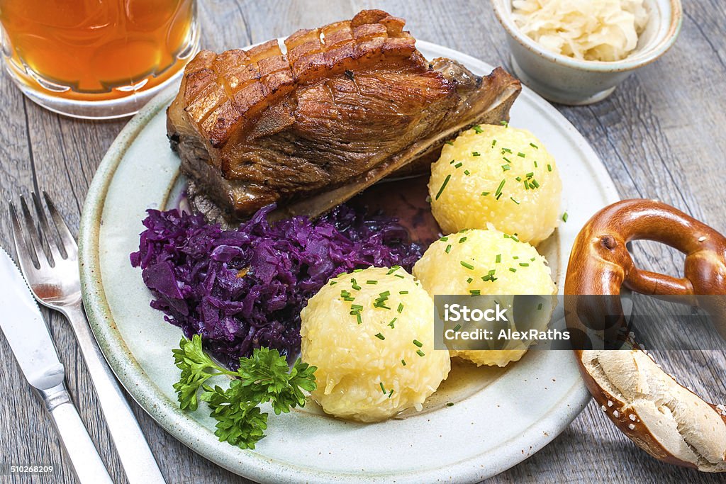 Bavarian meal Appetizing Bavarian roast pork dish with dumplings and pretzel Alcohol - Drink Stock Photo