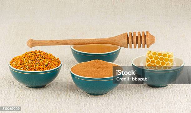 Honey Honeycomb Pollen Granules And Cinnamon In Bowls Stock Photo - Download Image Now