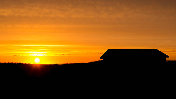istock Clouds & Sunsets - Silhouetted houses. 510271599