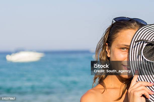 Sunny Portrait Of A Young Brunette Relaxing At The Beach Stock Photo - Download Image Now