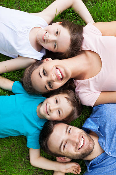 istock Family outdoors lying on grass 510284399
