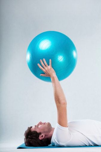 Closeup of patient exercising on floor exercise mat