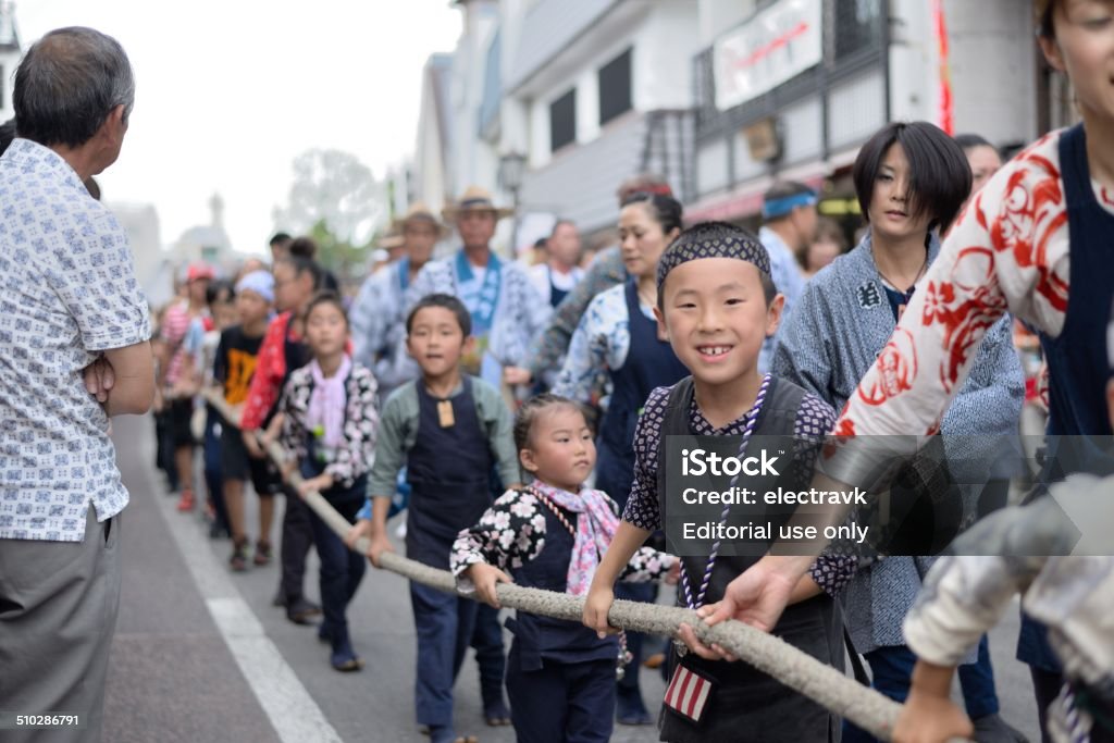 Narita Gion Matsuri Narita, Japan - July 6, 2014: Participants of all ages at the Narita Gion Matsuri drawing a mikoshi float in the city of Narita. Asia Stock Photo