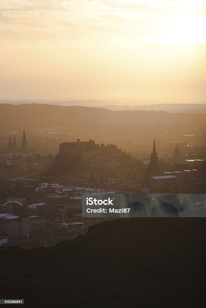 Sunset over Edinburgh The Edinburgh Castle seen from the top of the Arthur's Seat during sunset. Arthur's Seat Stock Photo