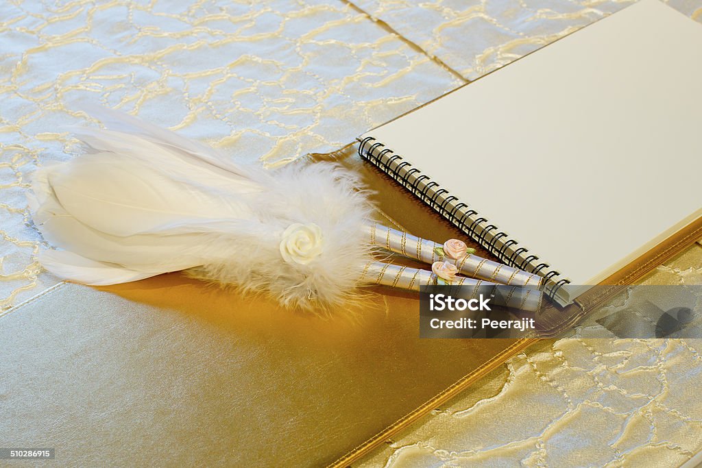 Photo of a wedding register and feather pen. Wedding guestbook. Guest Book Stock Photo
