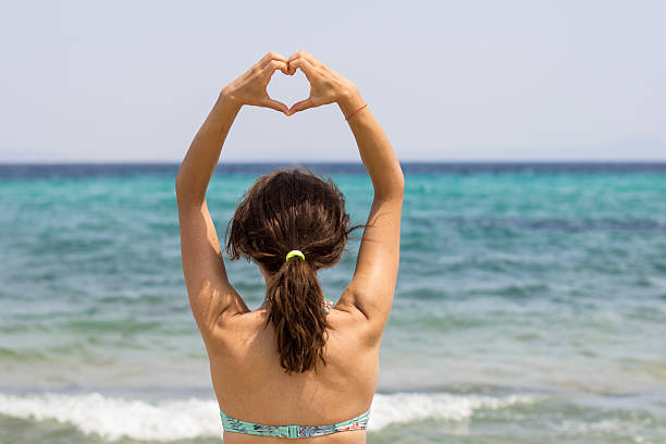 istock heart with hands on beach 510287799