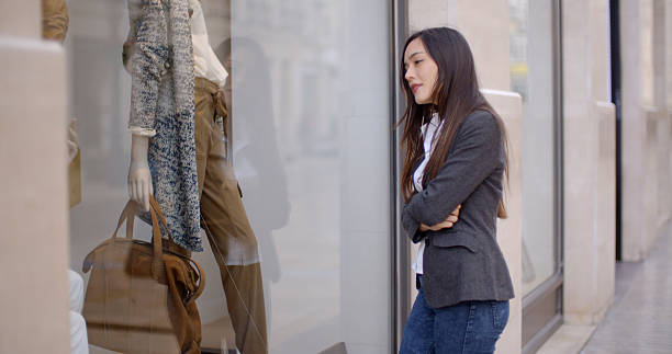istock Young woman looking at a shop mannequin 510301310