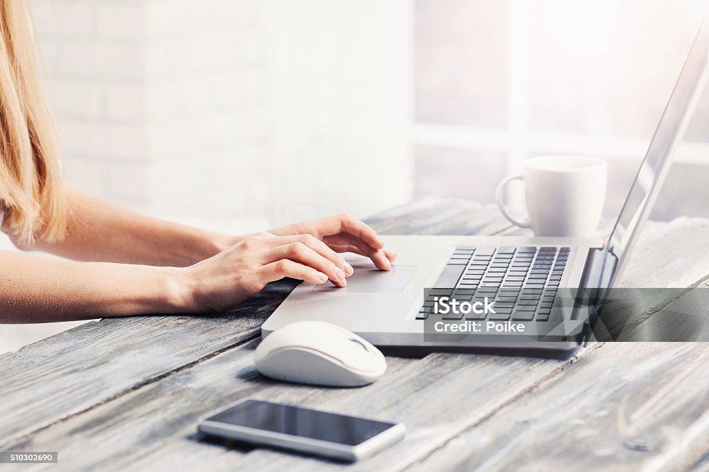 Place of work Close-up of female hands on laptop keyboard Laptop Stock Photo