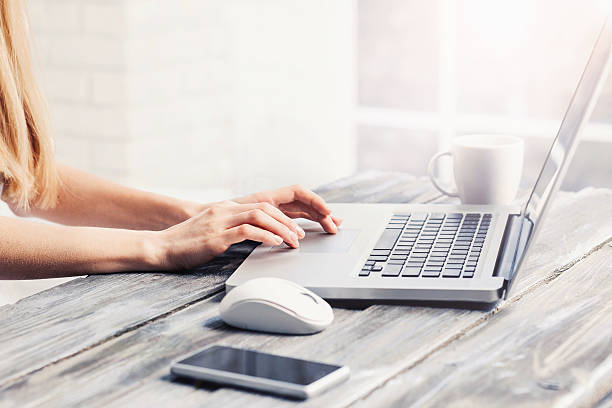 Place of work Close-up of female hands on laptop keyboard touchpad stock pictures, royalty-free photos & images