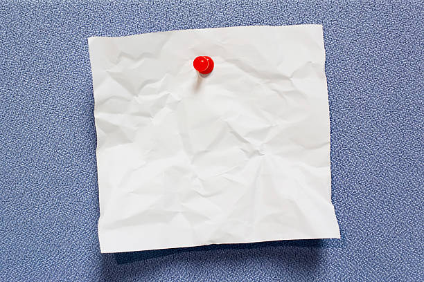 istock White crumpled paper note stick on board 510303188