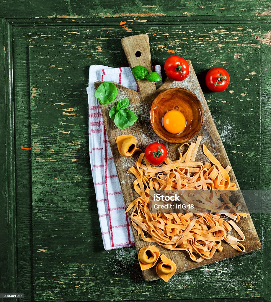 fresh tagliatelle pasta on a wooden table. Rustic style. Backgrounds Stock Photo