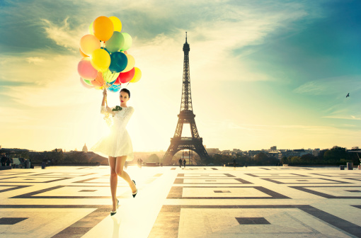 young attractive woman with bright balloons. Amazing sunrise on trocadero place and eiffel tower in Paris