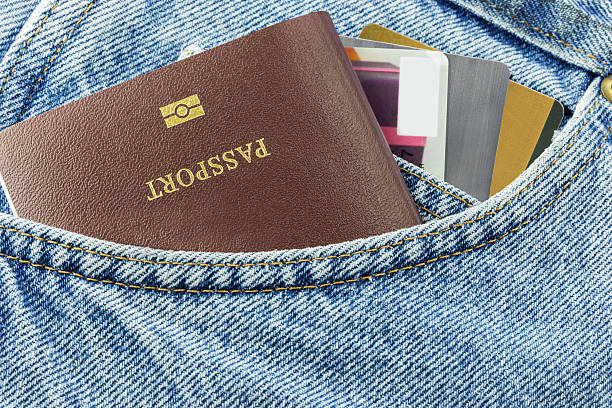 Credit card and passport in blue denim jeans Closeup of credit card and passport in blue denim jeans pocket jeans denim passport pocket stock pictures, royalty-free photos & images