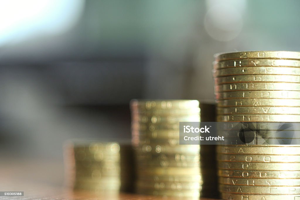 coins on the table. close-up gold coins on the table. close-up view, blured bokeh background, UAH Ukrainian hryvnia Graph Stock Photo