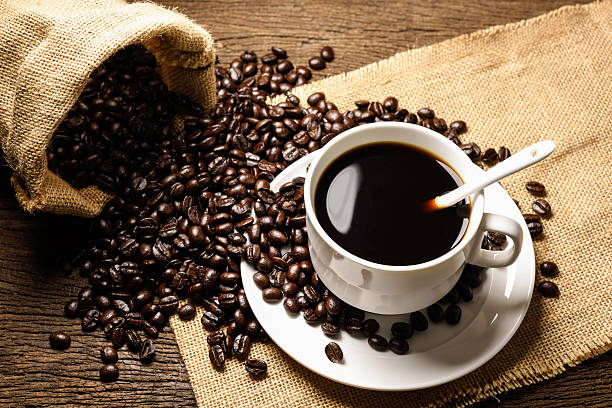 istock Coffee beans and cup on old wooden background 510306328
