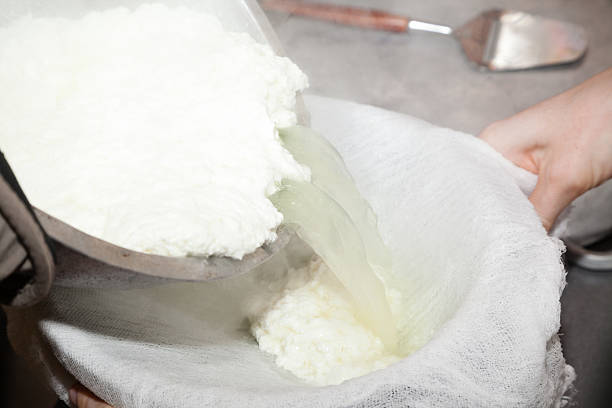 pouring paneer cheese stock photo