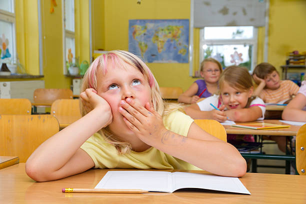 Schoolgirl yawning at lesson