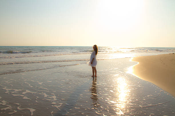 istock Young woman walking on water at sunset 510309073