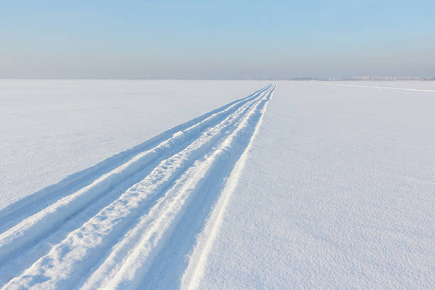 istock Traces from a snowmobile on a snow surface 510309700