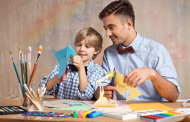 istock Father and son cutting paper 510309822