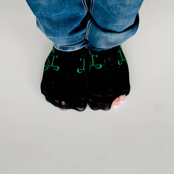 istock worn out socks with a hole and toe sticking out 510310737