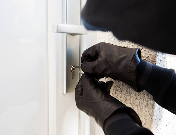 Burglar using special tools to break in  a house Burglar using special tools to break in  a house prowling stock pictures, royalty-free photos & images