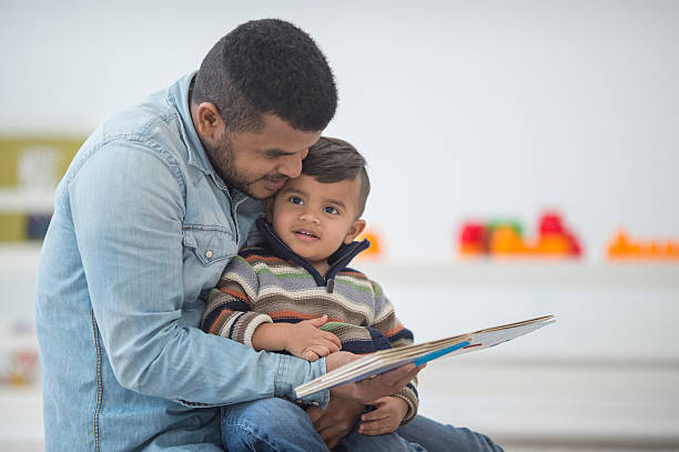 istock Father Reading a Book to His Son 510312034