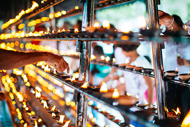 People set fire to the oil lamps  in The temple of the tooth, Sri lanka
