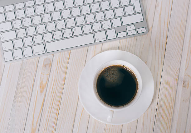 istock White laptop with coffee cup  on old wooden table 510319658