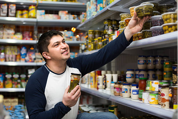 istock Young man buying tinned food 510320656