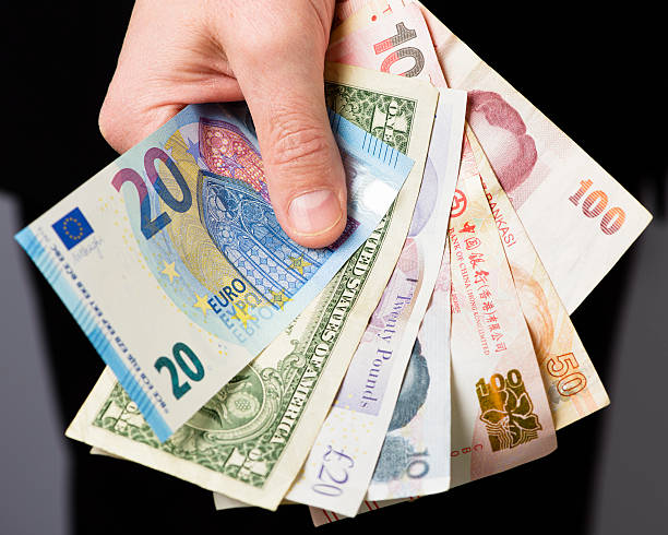 Man Holding Various International Currency Bank Notes A mature businessman holds a collection of of bank notes from different countries: Euro (EUR), American Dollar (USD), British Pound (GBP), Chinese Yuan (CNY), Hong Kong Dollar (HKD), Turkish Lira (TRY), Thai Baht (THB). International trade / currency exchange concept. hong kong currency symbol stock pictures, royalty-free photos & images