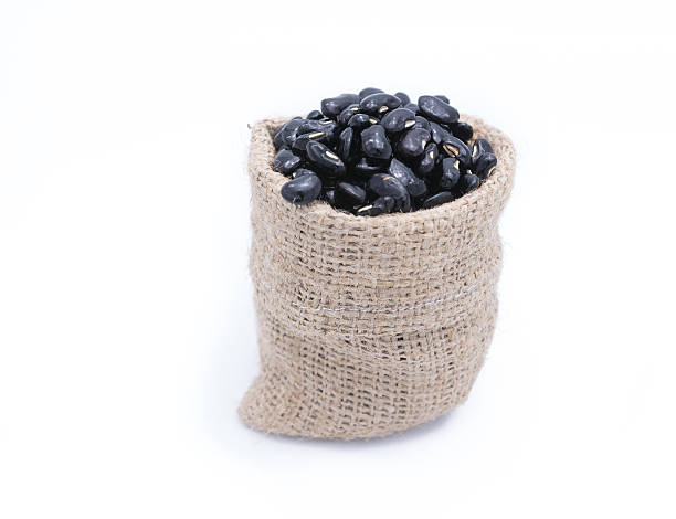 istock Black beans in gunny bag isolated on white background 510324936