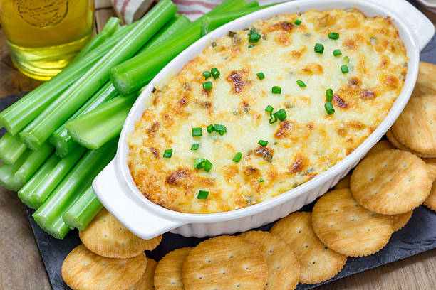 Baked crab dip, served with celery sticks and crackers stock photo
