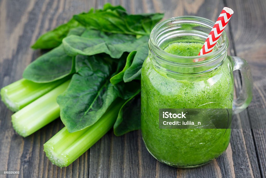 Green smoothie with celery, cucumber, spinach, apple, lemon in glass Celery Stock Photo