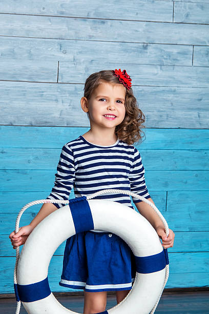 istock child standing and holding a lifebuoy 510327650