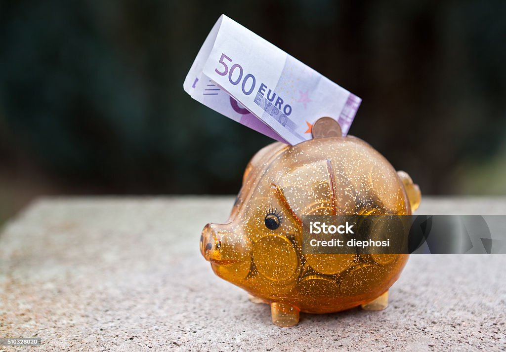 The end of the € 500 bill A 500 € bill infected out of a piggy bank Piggy Bank Stock Photo