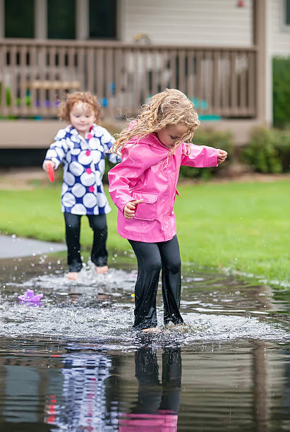 istock Girls Jumping in Puddle 510331953