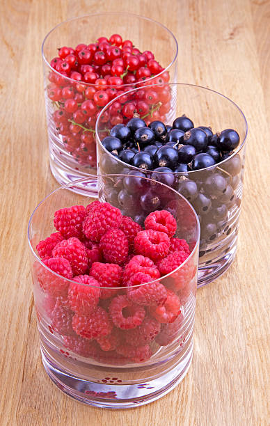 istock Black, red currants and raspberries in glasses 510333383
